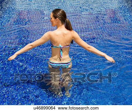 Woman relaxing in pool View Large Photo Image Picture - Woman relaxing in pool. Fotosearch