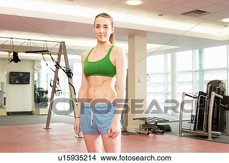 Woman standing in gymnasium View Large Photo Image Picture - Woman standing in gymnasium. Fotosearch