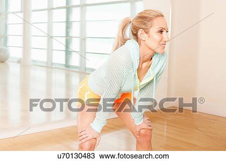 Stock Image - Woman standing in gymnasium. Fotosearch
