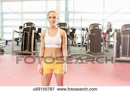 Woman standing in gymnasium View Large Photo Image Stock Photo - Woman standing in gymnasium. Fotosearch