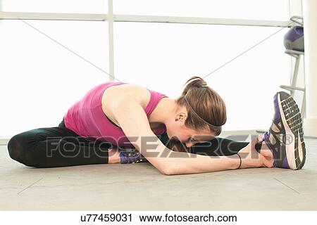 Woman stretching warming up View Large Photo Image Stock Image - Woman stretching warming up. Fotosearch