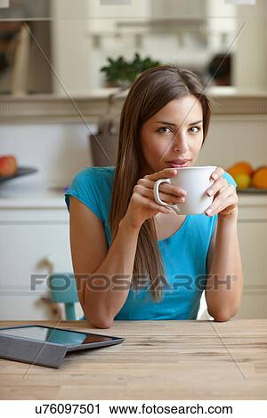 Stock Image - Woman taking coffee break. Fotosearch