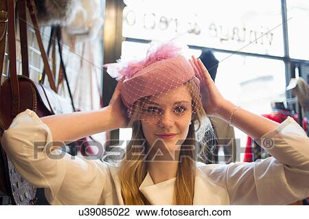 Woman trying on vintage hat View Large Photo Image Stock Image - Woman trying on vintage hat. Fotosearch