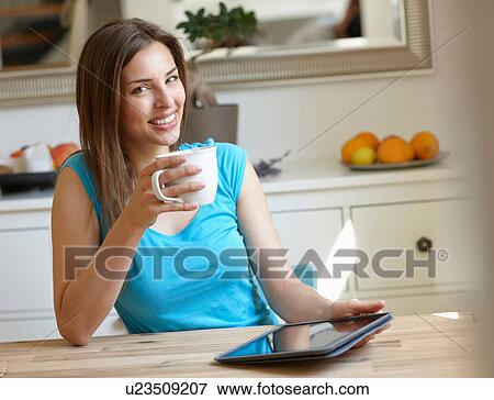Woman using digital tablet at coffee-break View Large Photo Image Stock Photo - Woman using digital tablet at coffee-break. Fotosearch