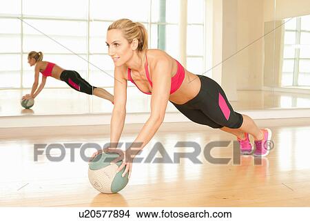 Woman using exercise ball View Large Photo Image Picture - Woman using exercise ball. Fotosearch