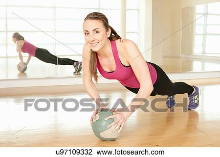 Woman using exercise ball View Large Photo Image Stock Image - Woman using exercise ball. Fotosearch