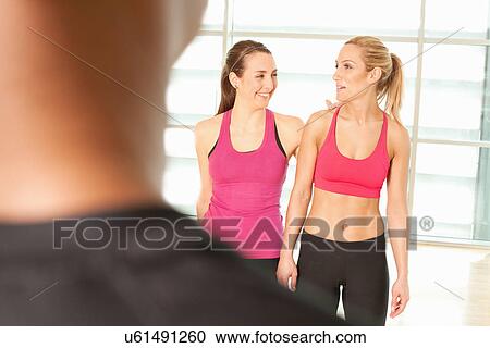Women standing together in exercise class View Large Photo Image Stock Image - Women standing together in exercise class. Fotosearch
