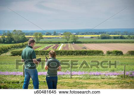 Workers using walkie talkie View Large Photo Image Stock Photography - Workers using walkie talkie. Fotosearch