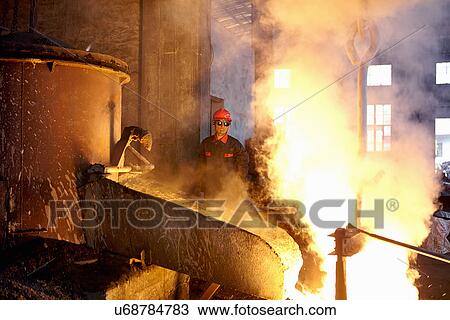 Stock Image - Working in cast iron foundry. Fotosearch
