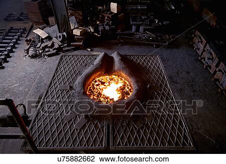 Stock Image - Working in cast iron foundry. Fotosearch
