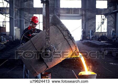 Stock Image - Working in cast iron foundry. Fotosearch