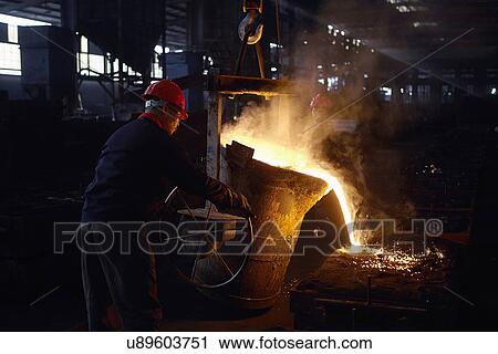 Stock Image - Working in cast iron foundry. Fotosearch