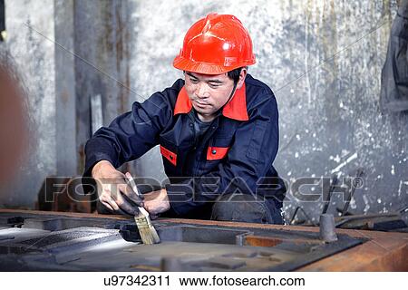 Stock Image - Working in cast iron foundry. Fotosearch