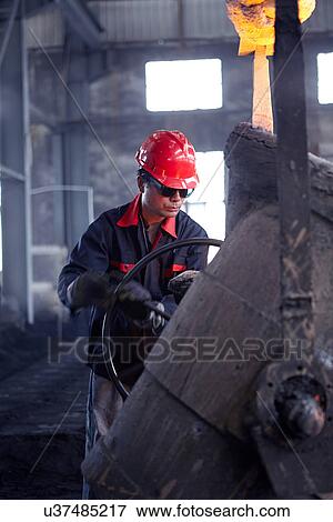 Stock Photo - Working in cast iron foundry. Fotosearch