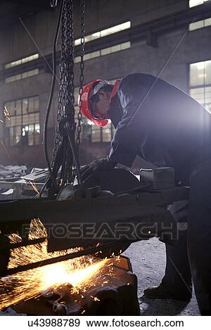 Stock Photo - Working in cast iron foundry. Fotosearch