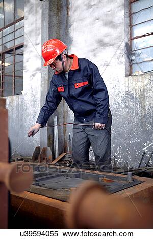 Stock Photography - Working in cast iron foundry. Fotosearch