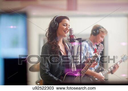 Young band playing music in recoding studio View Large Photo Image Stock Image - Young band playing music in recoding studio. Fotosearch