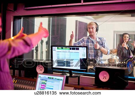 Stock Photography - Young band recording in studio. Fotosearch