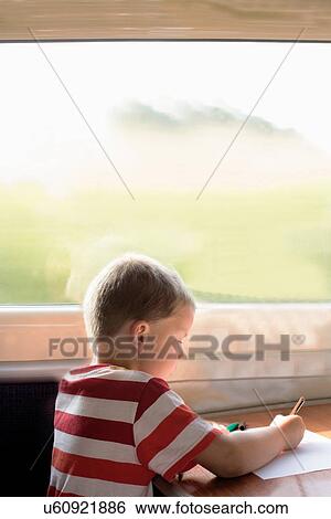 Stock Photograph - Young boy drawing on train. Fotosearch