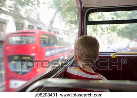 Stock Image - Young boy on double decker bus in London. Fotosearch