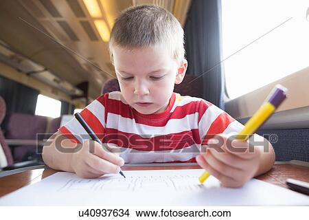 Young boy with pencil, pen and paper on train View Large Photo Image Picture - Young boy with pencil, pen and paper on train. Fotosearch