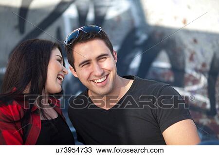 Young couple in front of graffiti View Large Photo Image Stock Image - Young couple in front of graffiti. Fotosearch