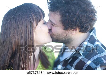 Young couple kissing View Large Photo Image Picture - Young couple kissing. Fotosearch