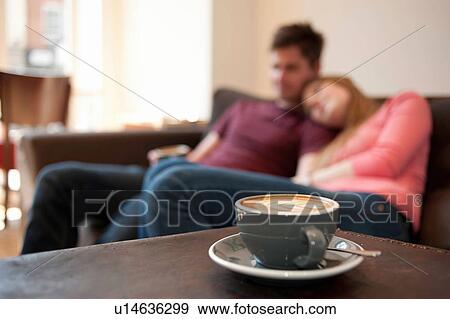 Young couple lounging on cafe sofa View Large Photo Image Stock Photo - Young couple lounging on cafe sofa. Fotosearch