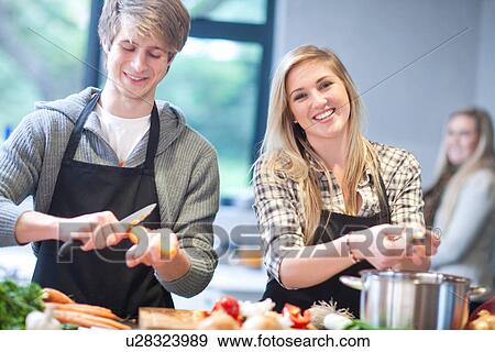 Young couple preparing food View Large Photo Image Stock Photo - Young couple preparing food. Fotosearch