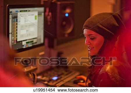 Picture - Young female in college recording studio. Fotosearch