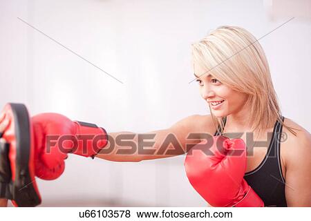 Young female training in boxing gloves View Large Photo Image Stock Photo - Young female training in boxing gloves. Fotosearch