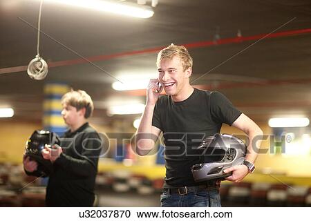 Stock Image - Young man and boy at go cart track. Fotosearch