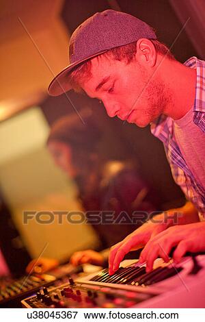 Stock Photo - Young man in college recording studio. Fotosearch