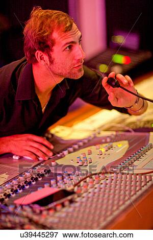 Young man on mixing desk View Large Photo Image Stock Photo - Young man on mixing desk. Fotosearch