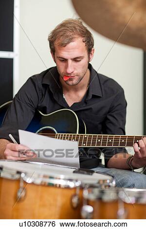 Young musician making notes View Large Photo Image Stock Photograph - Young musician making notes. Fotosearch