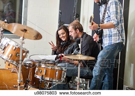 Young musicians looking at sheet music View Large Photo Image Stock Image - Young musicians looking at sheet music. Fotosearch