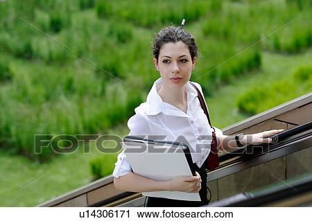 Young office worker on outdoor escalator View Large Photo Image Stock Image - Young office worker on outdoor escalator. Fotosearch