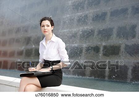 Young office worker sitting on bench with files View Large Photo Image Stock Image - Young office worker sitting on bench with files. Fotosearch