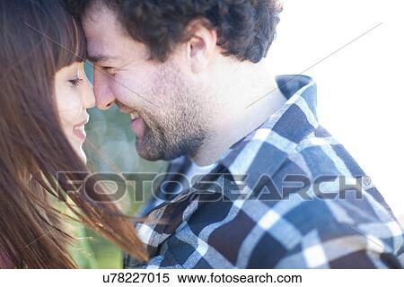 Stock Photography - Young smiling couple head to head. Fotosearch