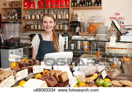 Young woman behind kitchen counter in cafe View Large Photo Image Picture - Young woman behind kitchen counter in cafe. Fotosearch