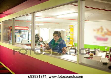 Young woman in cafe window View Large Photo Image Stock Image - Young woman in cafe window. Fotosearch