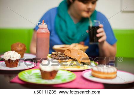 Young woman in cafe with table of food View Large Photo Image Stock Photography - Young woman in cafe with table of food. Fotosearch