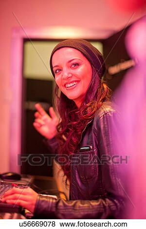 Stock Photo - Young woman in college recording studio. Fotosearch