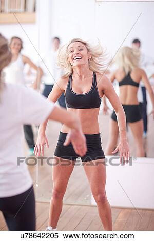 Young woman jumping in aerobic class View Large Photo Image Stock Photography - Young woman jumping in aerobic class. Fotosearch