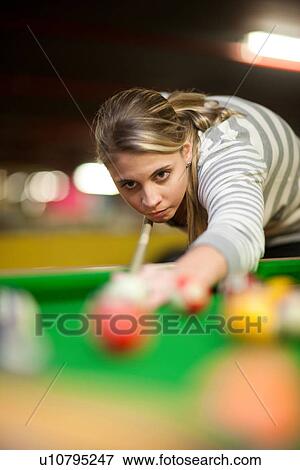 Stock Photo - Young woman playing pool. Fotosearch