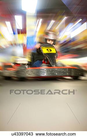 Young woman racing in go cart View Large Photo Image Stock Image - Young woman racing in go cart. Fotosearch