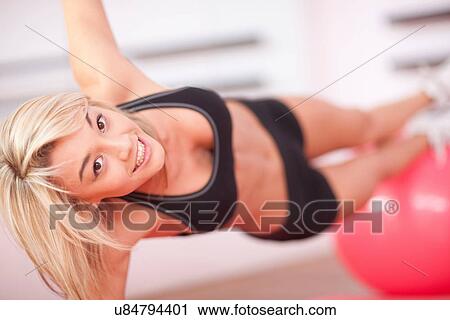 Young woman training with exercise ball View Large Photo Image Stock Image - Young woman training with exercise ball. Fotosearch