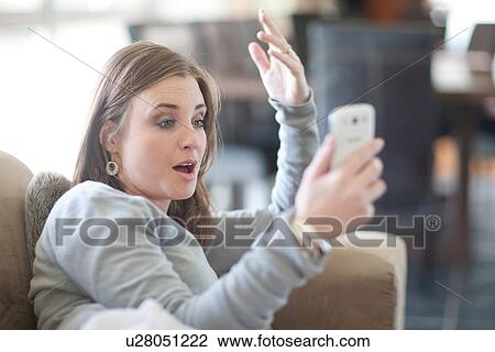 Young woman using cellphone for video call View Large Photo Image Stock Image - Young woman using cellphone for video call. Fotosearch