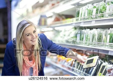 Young women looking at herbs in supermarket View Large Photo Image Stock Photograph - Young women looking at herbs in supermarket. Fotosearch