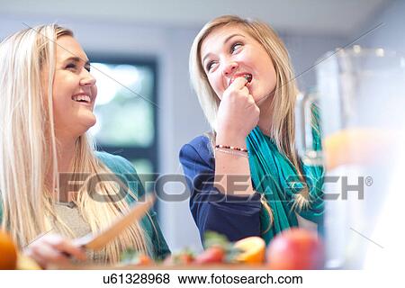 Young women preparing fruit drink View Large Photo Image Stock Photo - Young women preparing fruit drink. Fotosearch